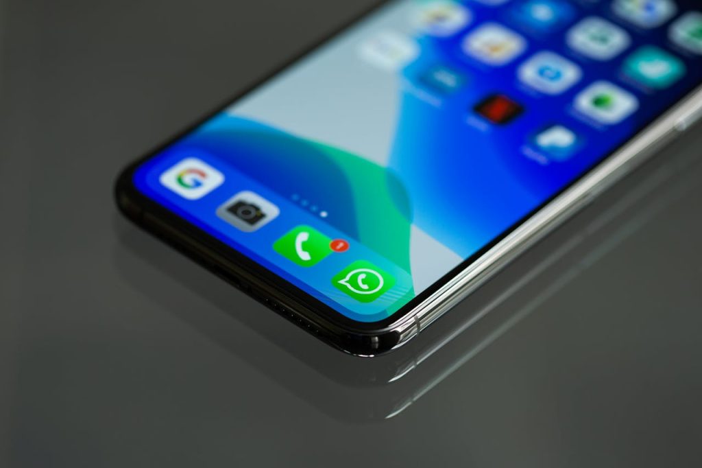 close-up-photo-of-smartphone-3571094 Close-up shot of a smartphone screen displaying various app icons including WhatsApp.